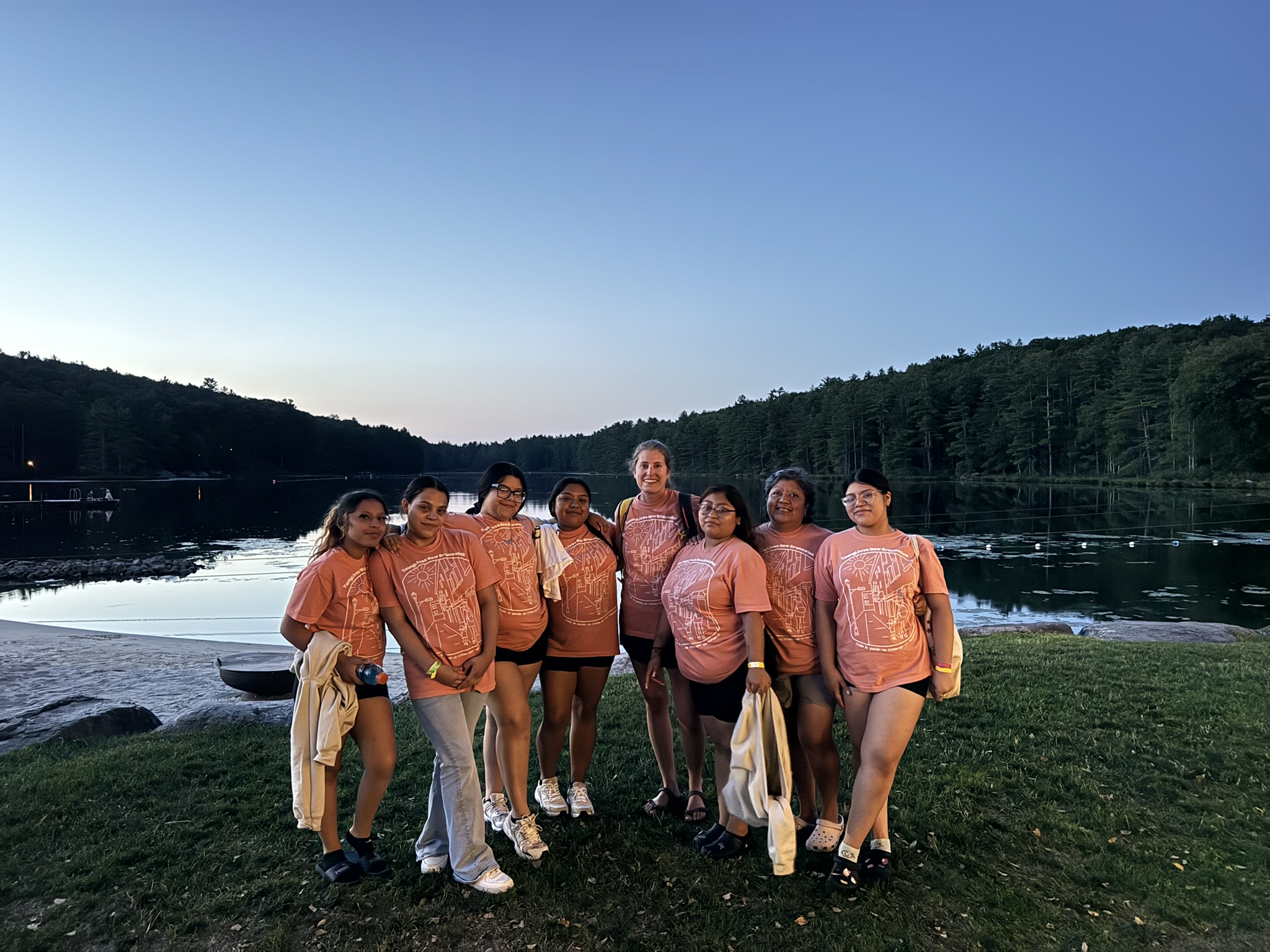 Teen moms and their kids gathered outdoors at summer camp