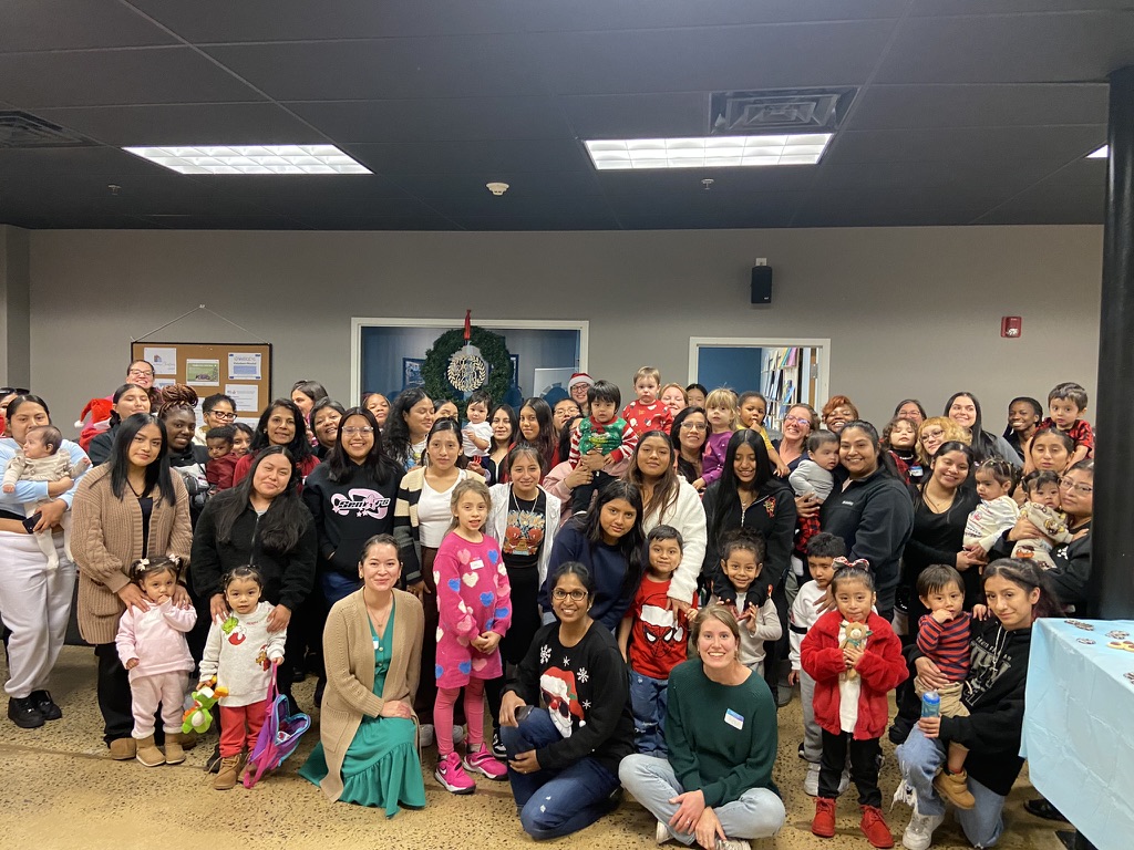 Moms and children together at a monthly outreach gathering
